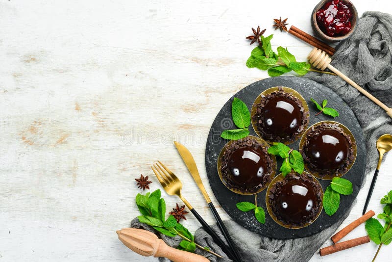 Chocolatemousse Dessert `Opera` on a Black Plate with Mint. Top View