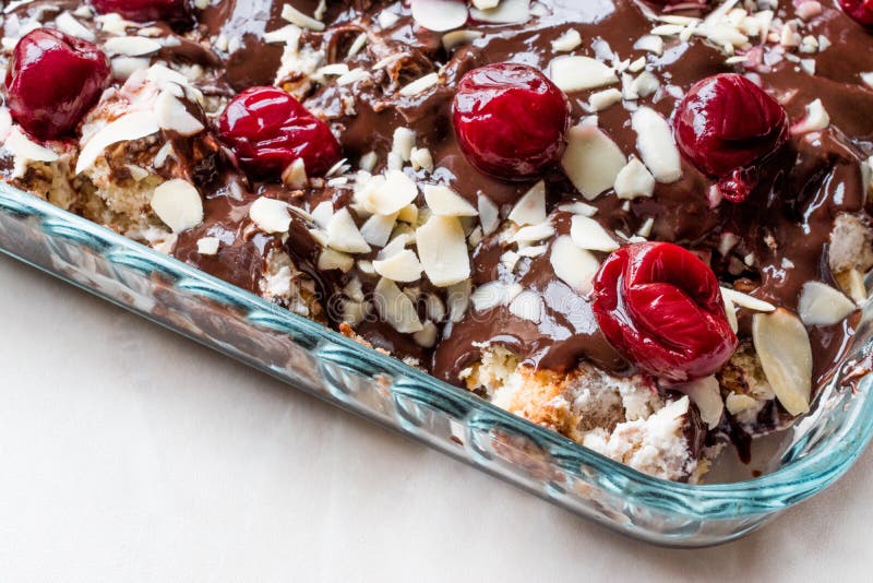 Chocolate Pudding Cake with Cherries, Almond Slices and Biscuits Stock