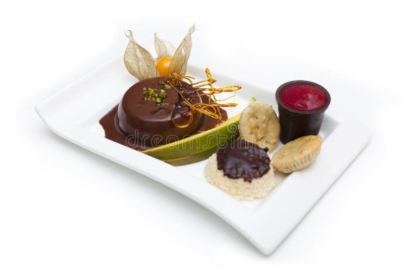 Chocolate pudding with fruits. Mexican spanish afters dessert with fruits like mango, coco cake and chocolate with strawberry or raspberry sauce royalty free stock photo Chocolate pudding with fruits. Mexican spanish afters dessert with fruits like mango, coco cake and chocolate with strawberry or raspberry sauce royalty free stock photo