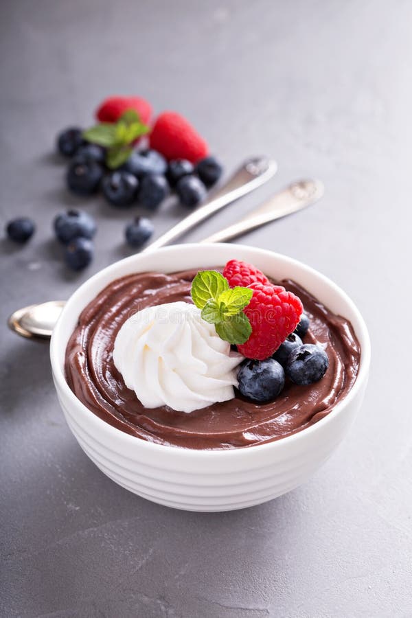 Chocolate pudding with whipped cream and berries