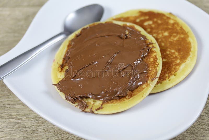 Chocolate spread pancake stock image. Image of plate 176904489