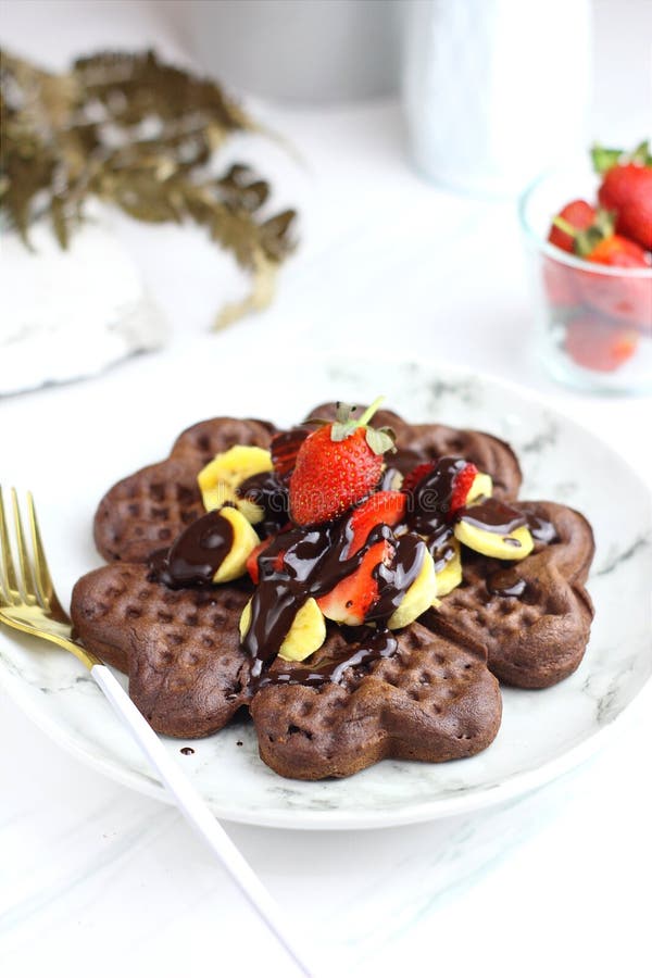 Chocolate Waffle with Chocolate Sauce and Slice Fruits Stock Photo