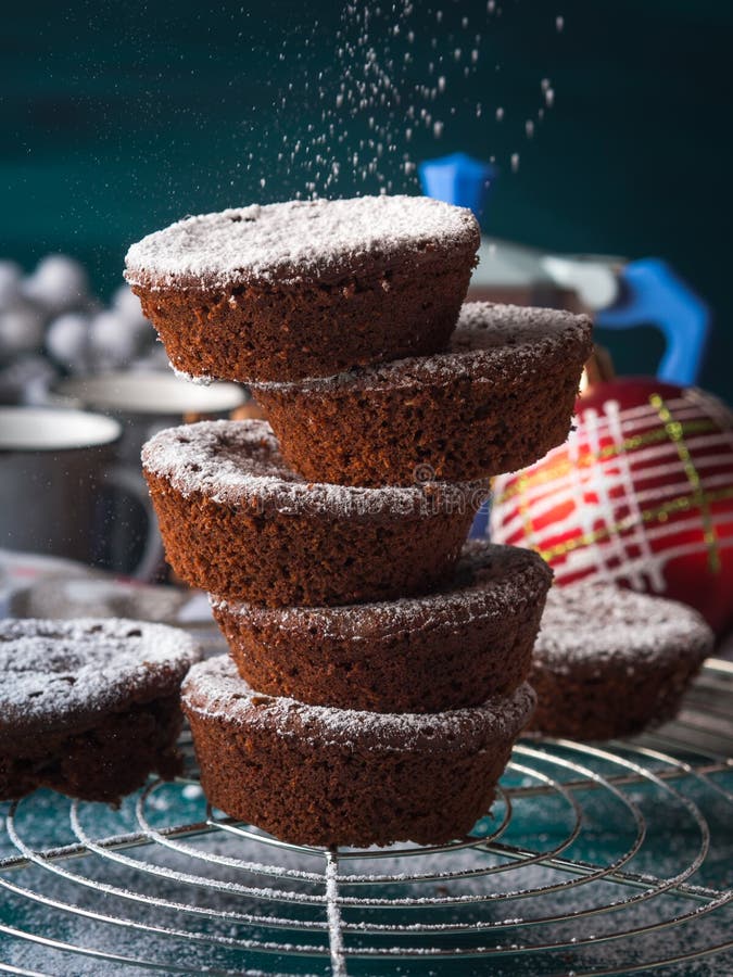 Chocolate Winter Muffins with Icing Sugar Stock Photo - Image of hand ...