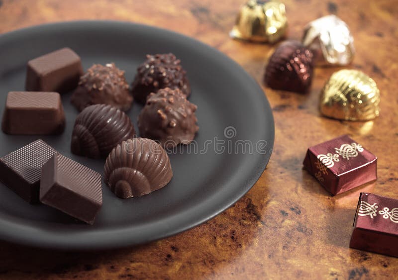 Chocolates in a Plate stock image. Image of studio, life 195880583