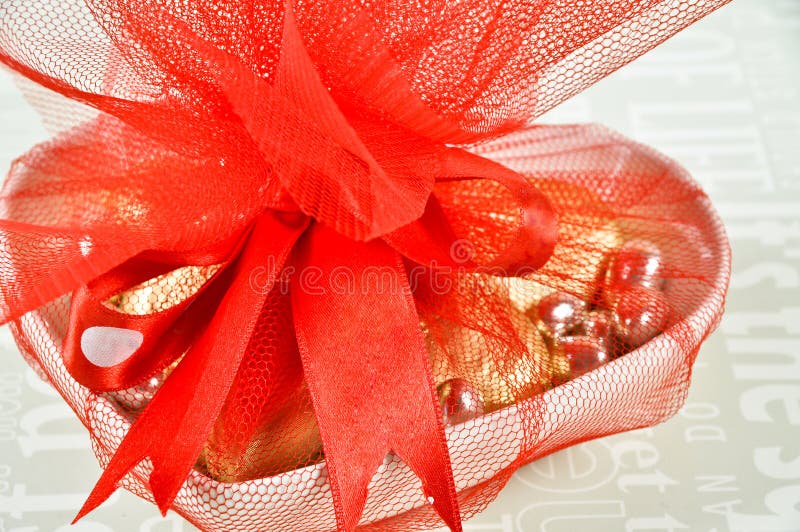 Chocolates Wrapped in Colored Foils Packed with Red Ribbon Stock Image