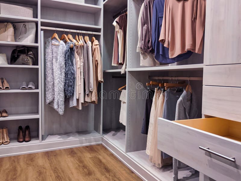 A well stocked walk in closet with all clothing and shoes organized within. A well stocked walk in closet with all clothing and shoes organized within