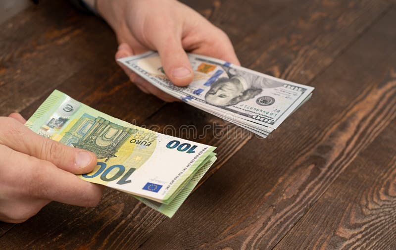 Choice Dollars Or Euros Exchange Dollars To Euro Money In Male Hand euro-to-dollar-exchange-rate-equals-in-first-parity-since-2002-eur-usd