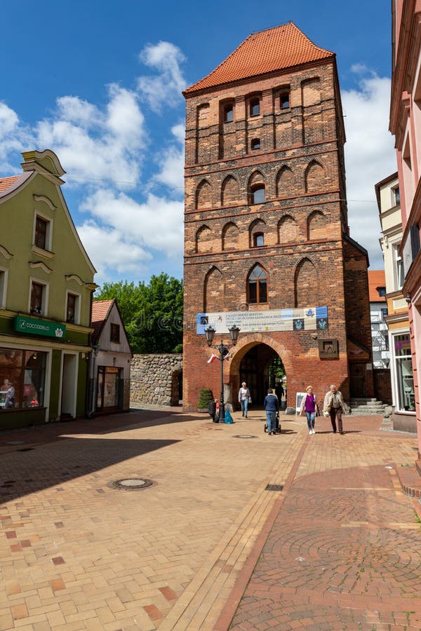 Chojnice, Pomorskie / Poland - May, 29, 2019: Old Gate in the city walls. Old brick buildings in a small city