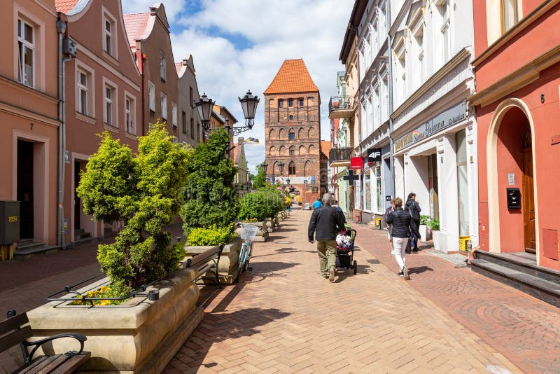 Chojnice, Pomorskie / Poland - May, 29, 2019: Old Gate in the city walls. Old brick buildings in a small city