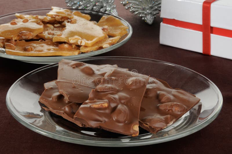 A plate of gourmet chocolate bark with almonds and peanut brittle. A plate of gourmet chocolate bark with almonds and peanut brittle