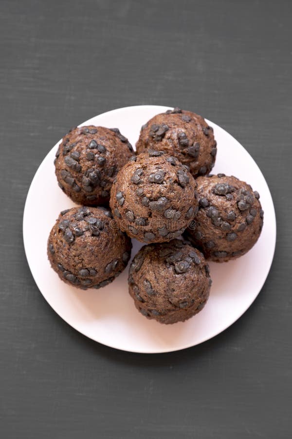 Chokladmuffin på rosa färgplattan på svart bakgrund, bästa sikt Lägenhet som är lekmanna-, från över, över huvudet Närbild royaltyfria foton Chokladmuffin på rosa färgplattan på svart bakgrund, bästa sikt Lägenhet som är lekmanna-, från över, över huvudet Närbild royaltyfria foton
