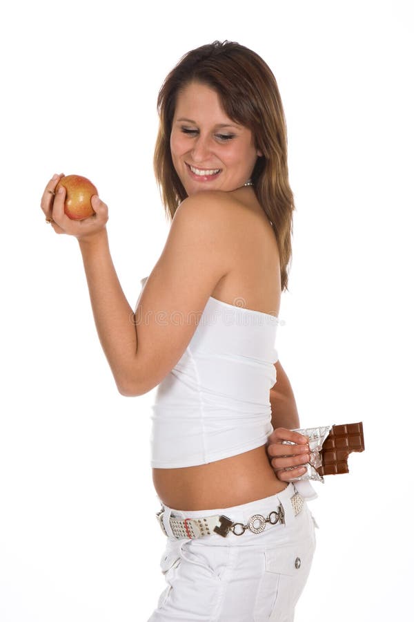 Attractive young woman hiding a chocolate bar behind her back. Attractive young woman hiding a chocolate bar behind her back