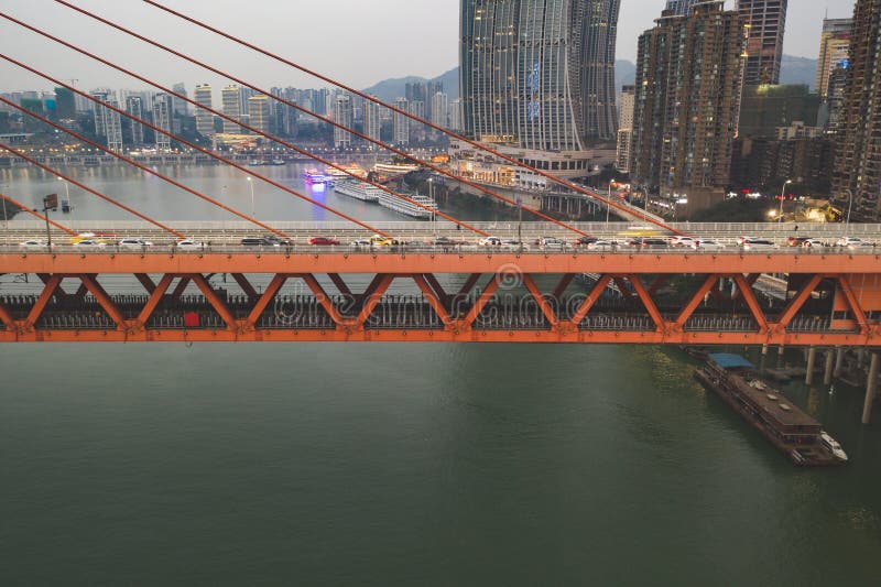 Chongqing, China - Dec 22, 2019: Qian si men suspension bridge over Jialing Rivier in cloudy weather. Chongqing, China - Dec 22, 2019: Qian si men suspension bridge over Jialing Rivier in cloudy weather