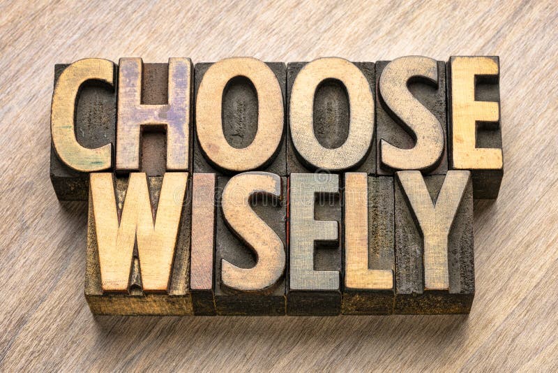 Choose wisely word abstract in wood type. Choose wisely word abstract in vintage letterpress wood type stock photo