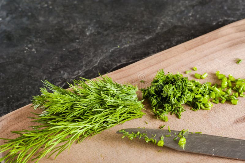 Chopped Bunch of Fresh Dill on a Black Stone Background. Stock Photo Image of garnish, cord