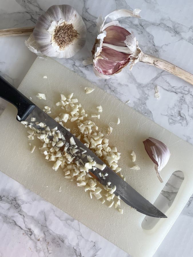 Chopped garlic and a knife stock photo. Image of ingredient 222760020