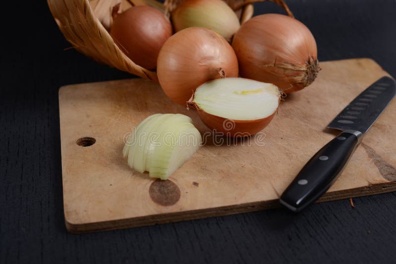 onions on a cutting board on a black background stock images onions on a cutting board on a black background stock images