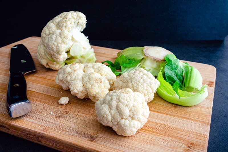 Chopping Cauliflower into Florets on a Bamboo Cutting Board Stock Image Image of sharp