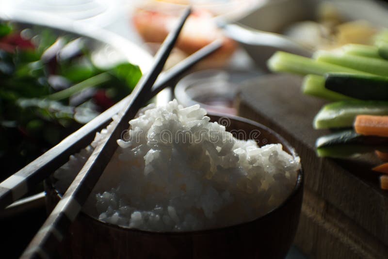 Chopsticks, rice and vegetables for cooking sushi top view. Asian cuisine