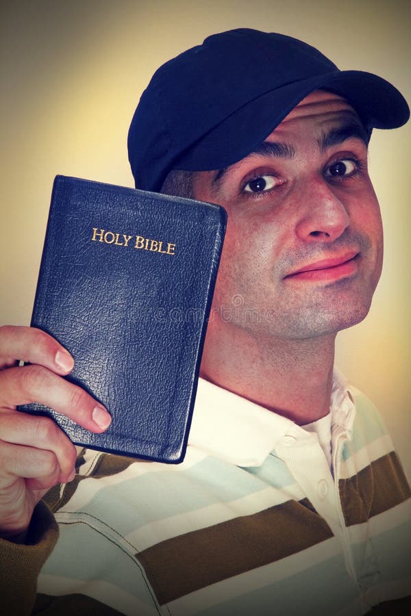 Cross-Processed photo of a Christian holding his Holy Bible. Cross-Processed photo of a Christian holding his Holy Bible.