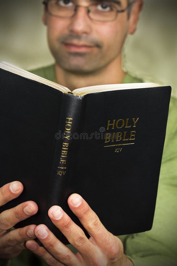 Christian guy holding his Holy Bible.