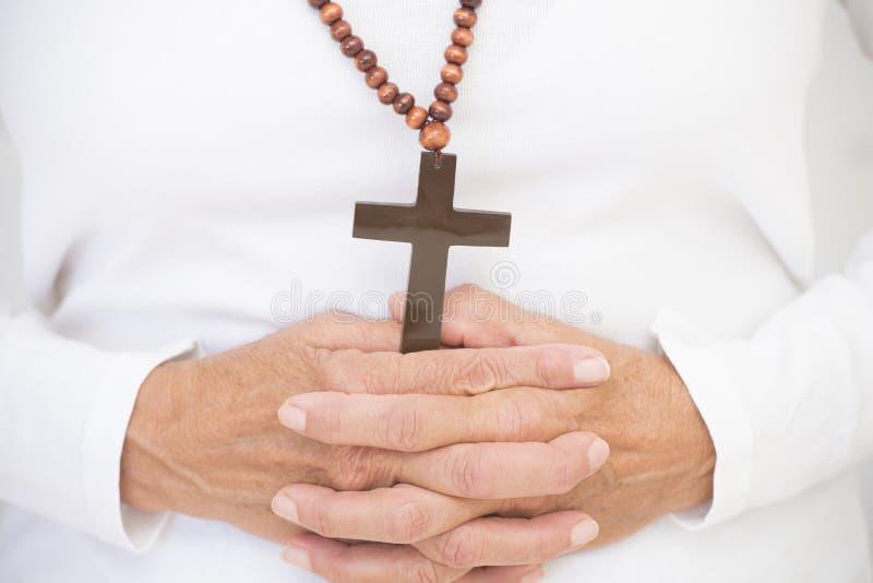 Christian crucifix and praying hands