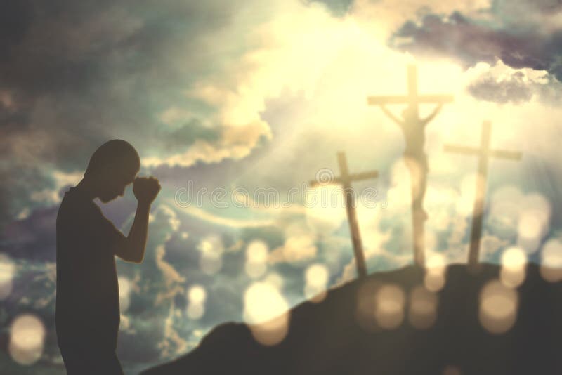 Christian man praying to God with three crucifixes stock image