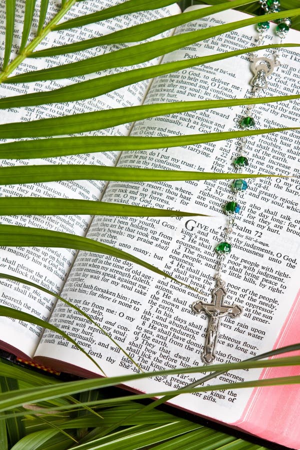Close up of rosary on bible pages with palm leaves. Close up of rosary on bible pages with palm leaves