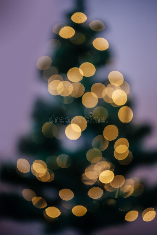 Christmas abstract background with blurry Christmas tree and Christmas lights bokeh, defocused Christmas tree