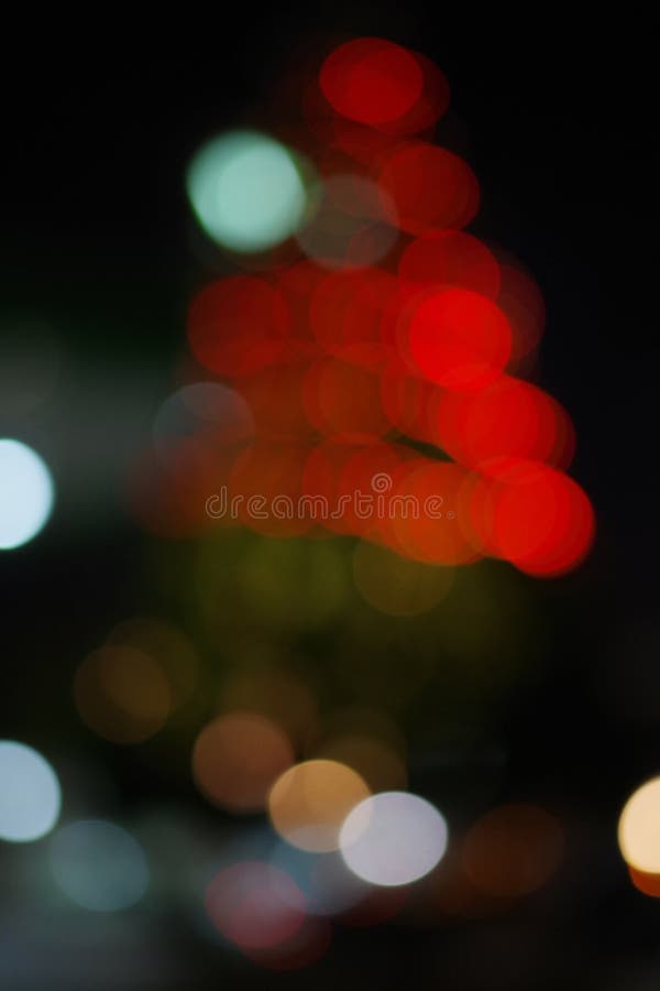 Christmas abstract defocused background, big christmas tree with lights glowing bokeh.