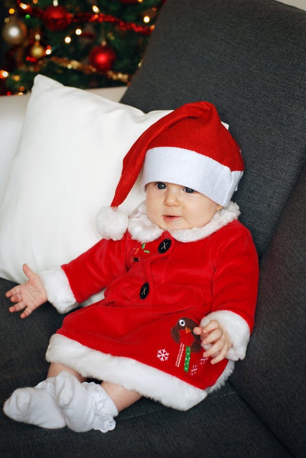 Christmas baby with a Christmas tree background stock photography