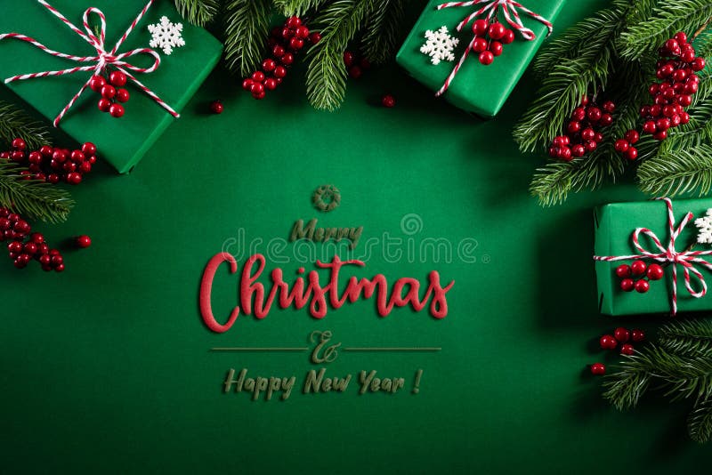 Christmas background concept. Top view of Christmas green gift box with decoration, spruce branches and red berries on green