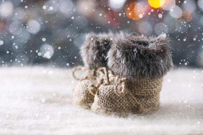 Christmas background with decorations on a Christmas tree handmade, winter boots. Soft focus.