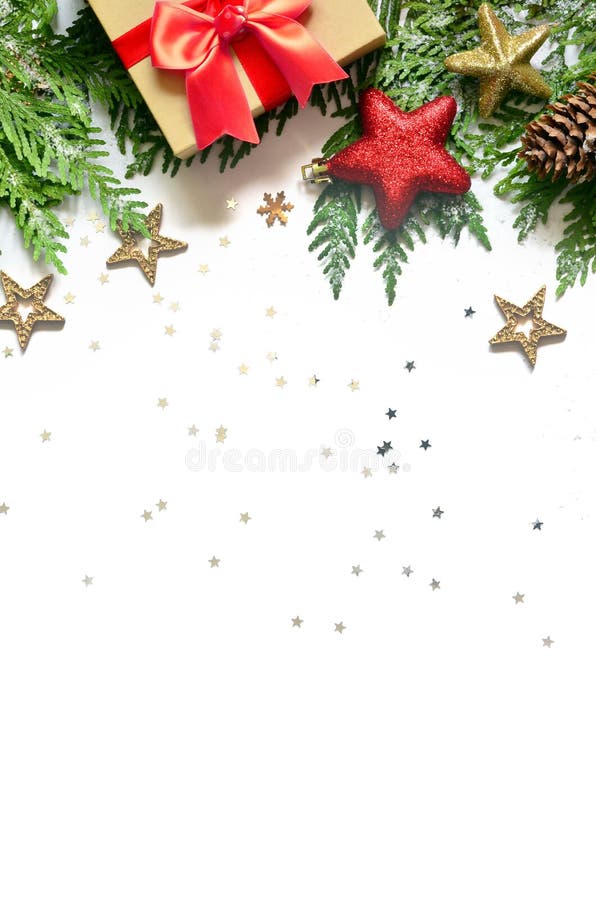 Christmas background, green pine branches, cones and gift box on white background. Creative composition with copy space