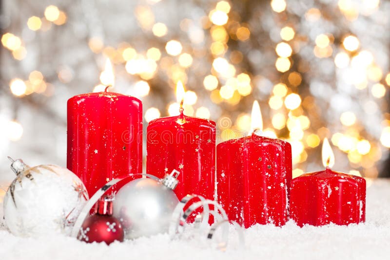 Christmas background with red candles and snow