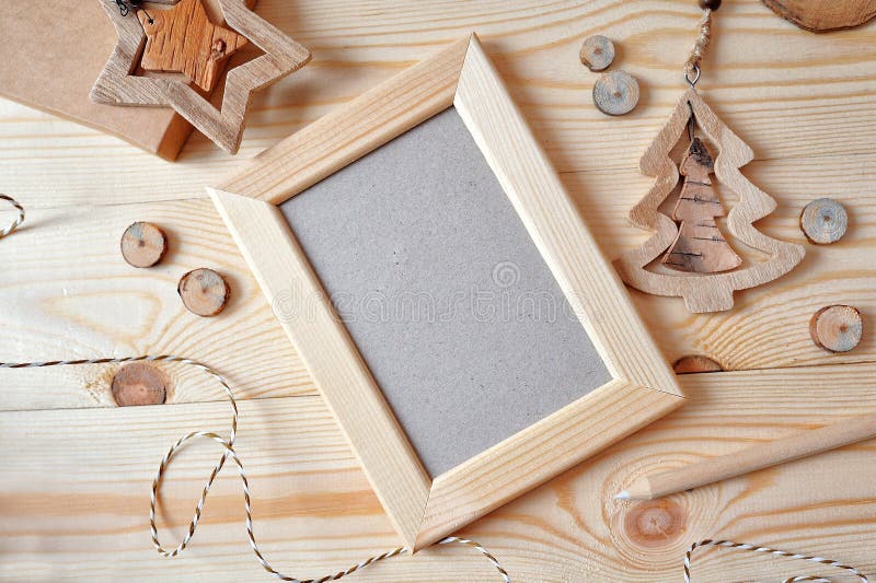 Christmas background with a wooden frame and a star and a Christmas tree. Flat lay, top view photo mockup