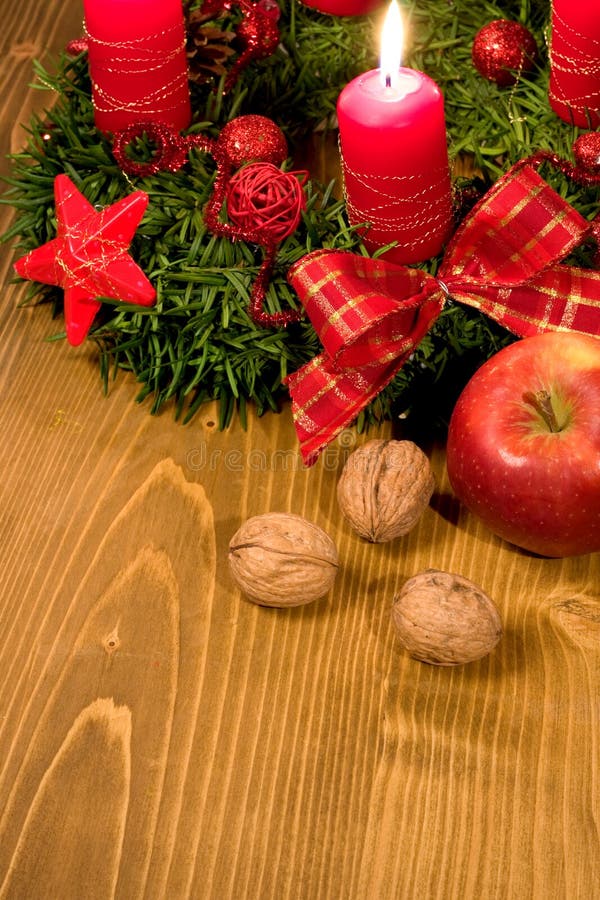 Christmas wreath with candle, apple and walnuts. Christmas wreath with candle, apple and walnuts