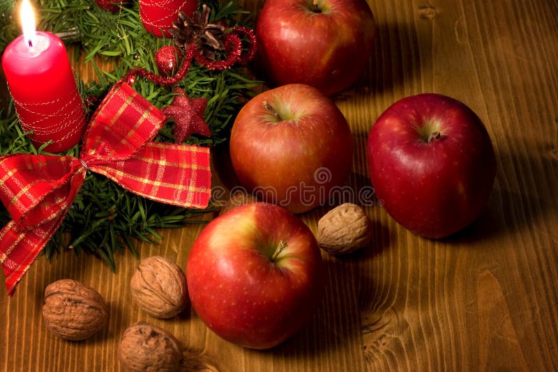 Christmas wreath with candle, apple and walnuts. Christmas wreath with candle, apple and walnuts