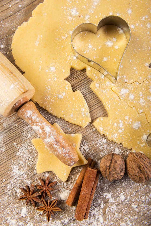 Christmas baking, cookies, rolling pin and spices on wood