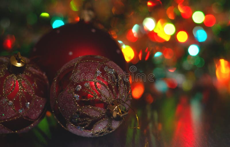 Christmas ball close-up on the background of the lights garland blurred purple and blue background.