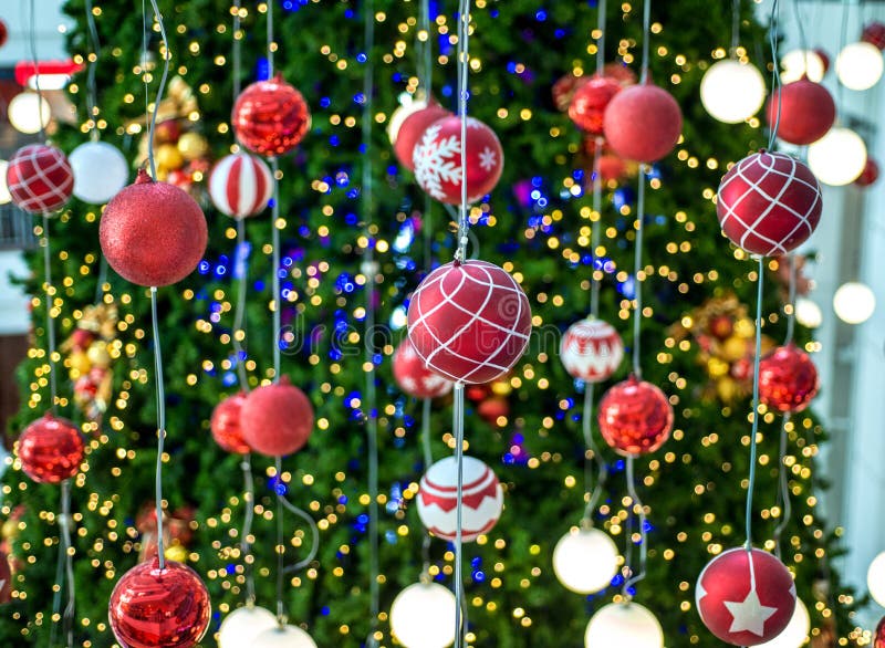 Christmas Ball Hanging on a Christmas Tree with Defocused Lights. Stock Photo Image of green