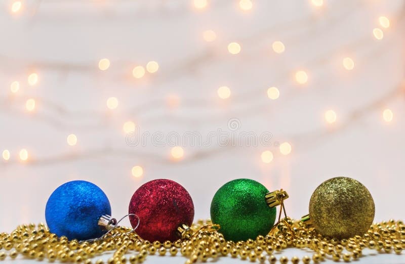 Christmas Balls and Beads on a Background Blur Lights Stock Photo