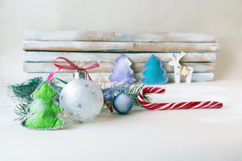 Christmas balls, snow, tree on a light background