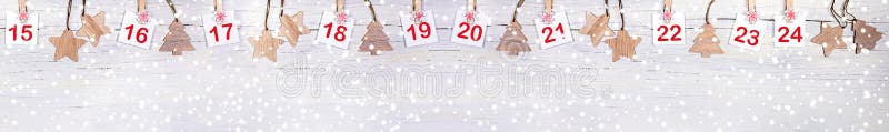 Christmas banner: part of Advent calendar with numbers on sheets and christmas toys on white wooden snowy background