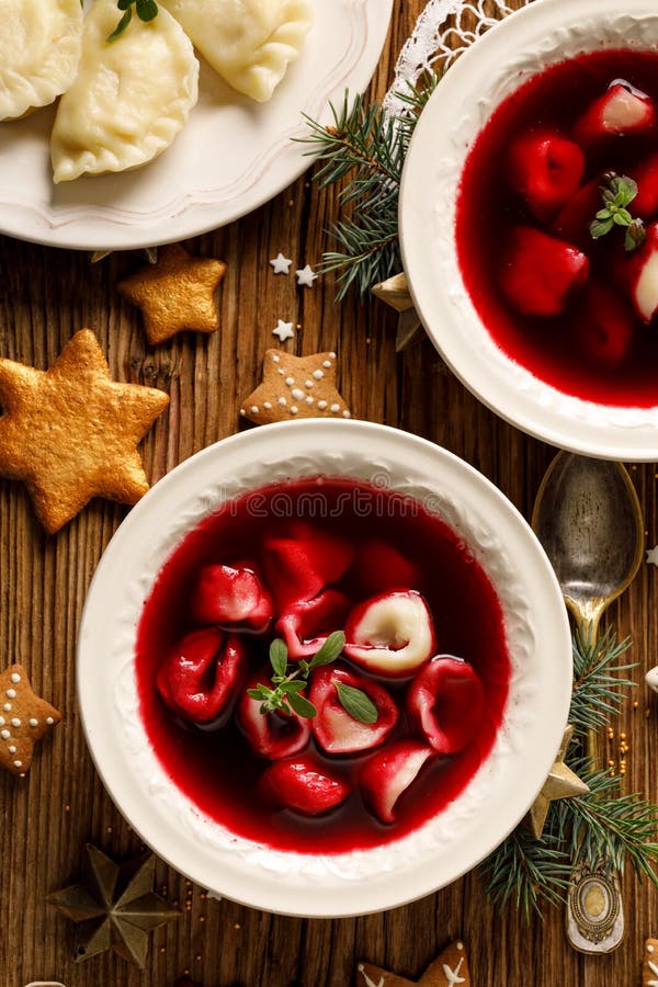 Christmas beetroot soup, borscht with small dumplings with mushroom filling in a ceramic bowl on a wooden table, top view. royalty free stock image Christmas beetroot soup, borscht with small dumplings with mushroom filling in a ceramic bowl on a wooden table, top view. royalty free stock image