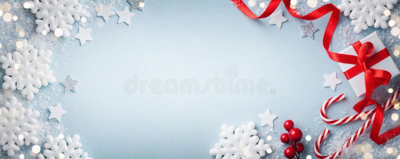 Christmas blue background. Gift or present box, white snowflakes and holiday decoration top view. Happy New Year card. Banner