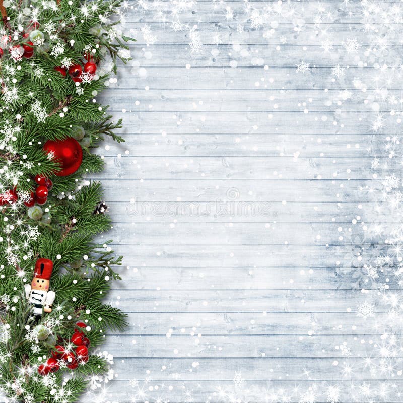 Christmas background with nutcracker, fir branches and holly on a snow vintage wooden background. with space for photos and congratulations. Christmas background with nutcracker, fir branches and holly on a snow vintage wooden background. with space for photos and congratulations