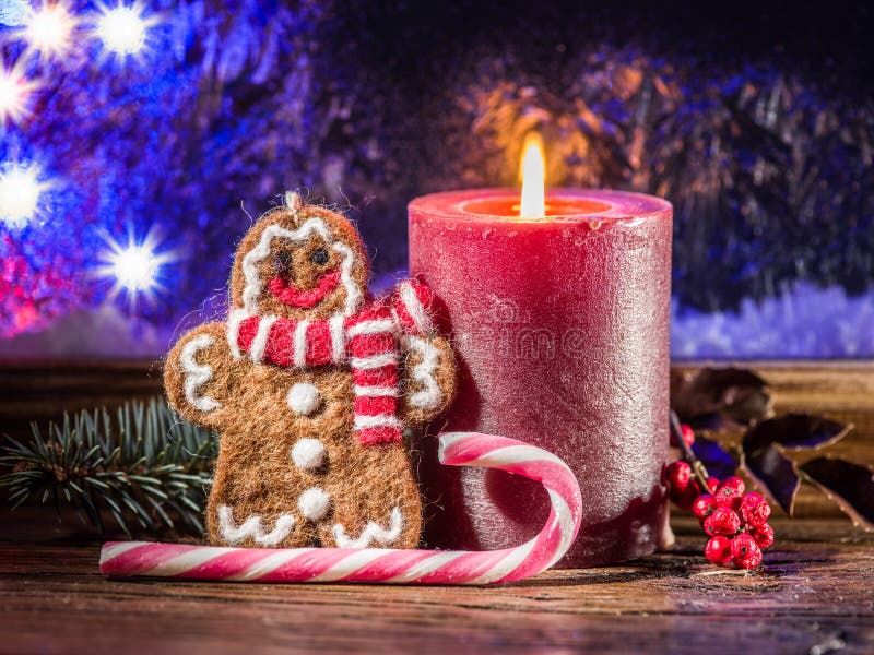 Christmas candle, ginger man toy and candy canes. Christmas symbols.
