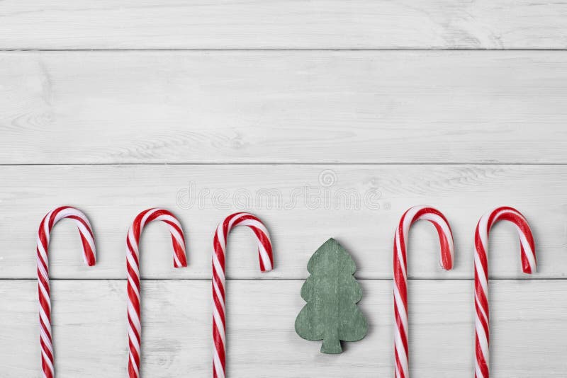 https://thumbs.dreamstime.com/b/christmas-candy-canes-tree-white-wooden-background-131693868.jpg