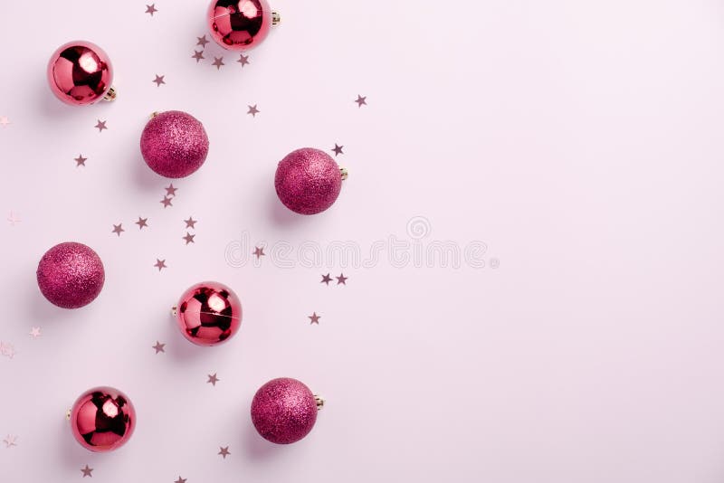 Christmas card. Christmas balls decoration on pastel pink background. Flat lay, top view, copy space